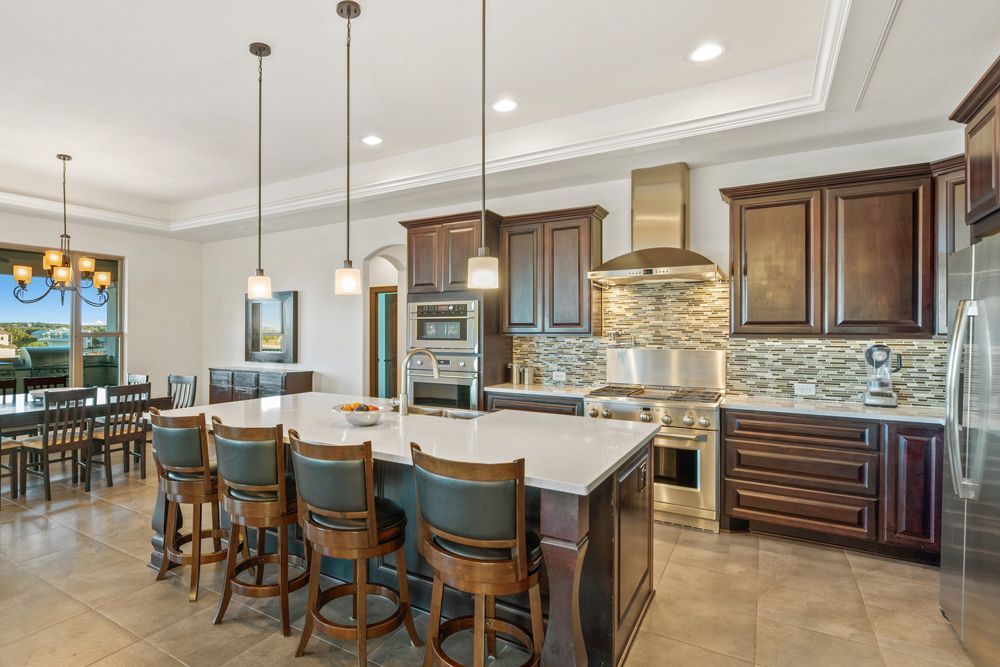 A large kitchen with stainless steel appliances and a large island.