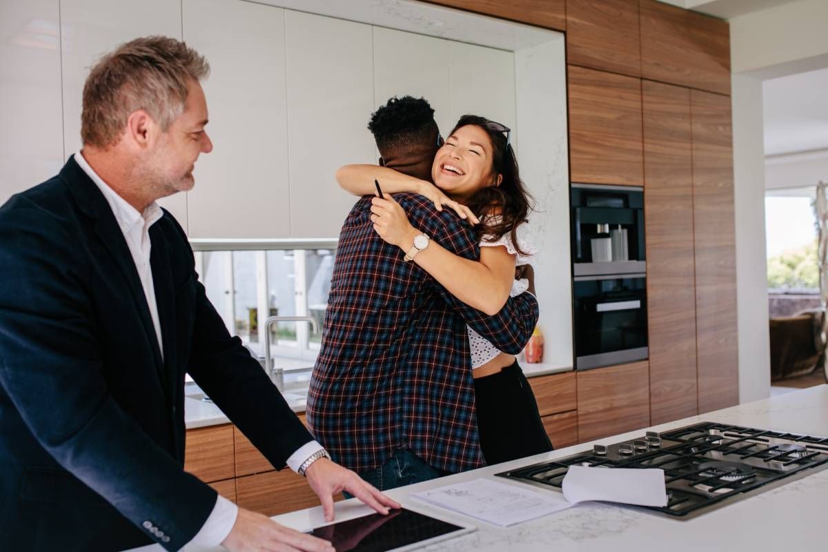 A realtor celebrating with first time home buyers near Lexington and Louisville, Kentucky (KY)