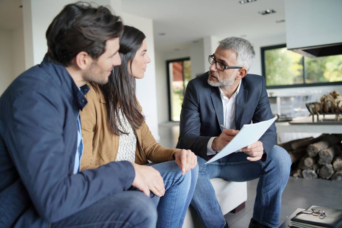 Real estate agent explaining appraisal gap coverage to prospective buyers.
