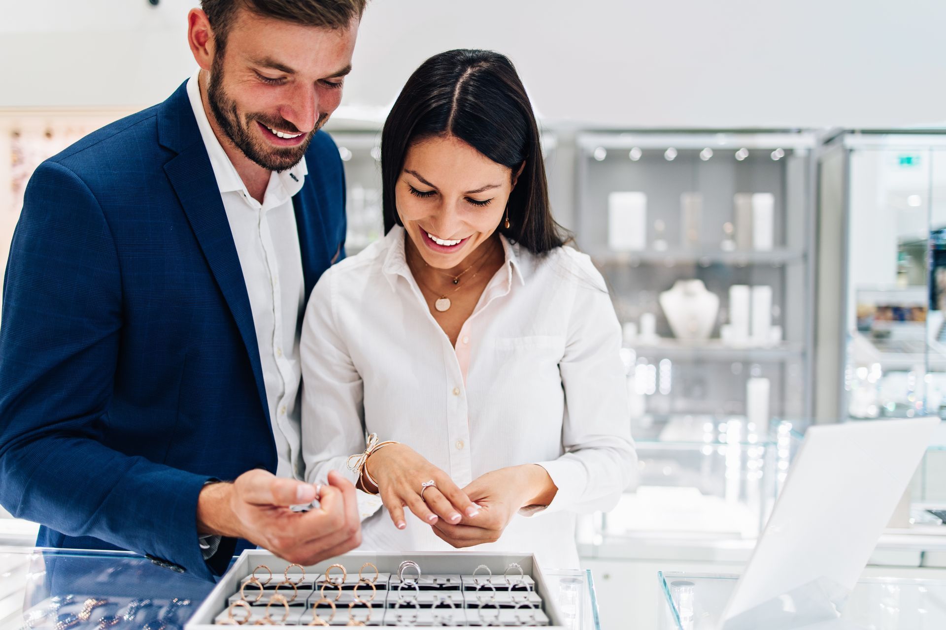 Beautiful couple enjoying shopping at a modern jewelry store.