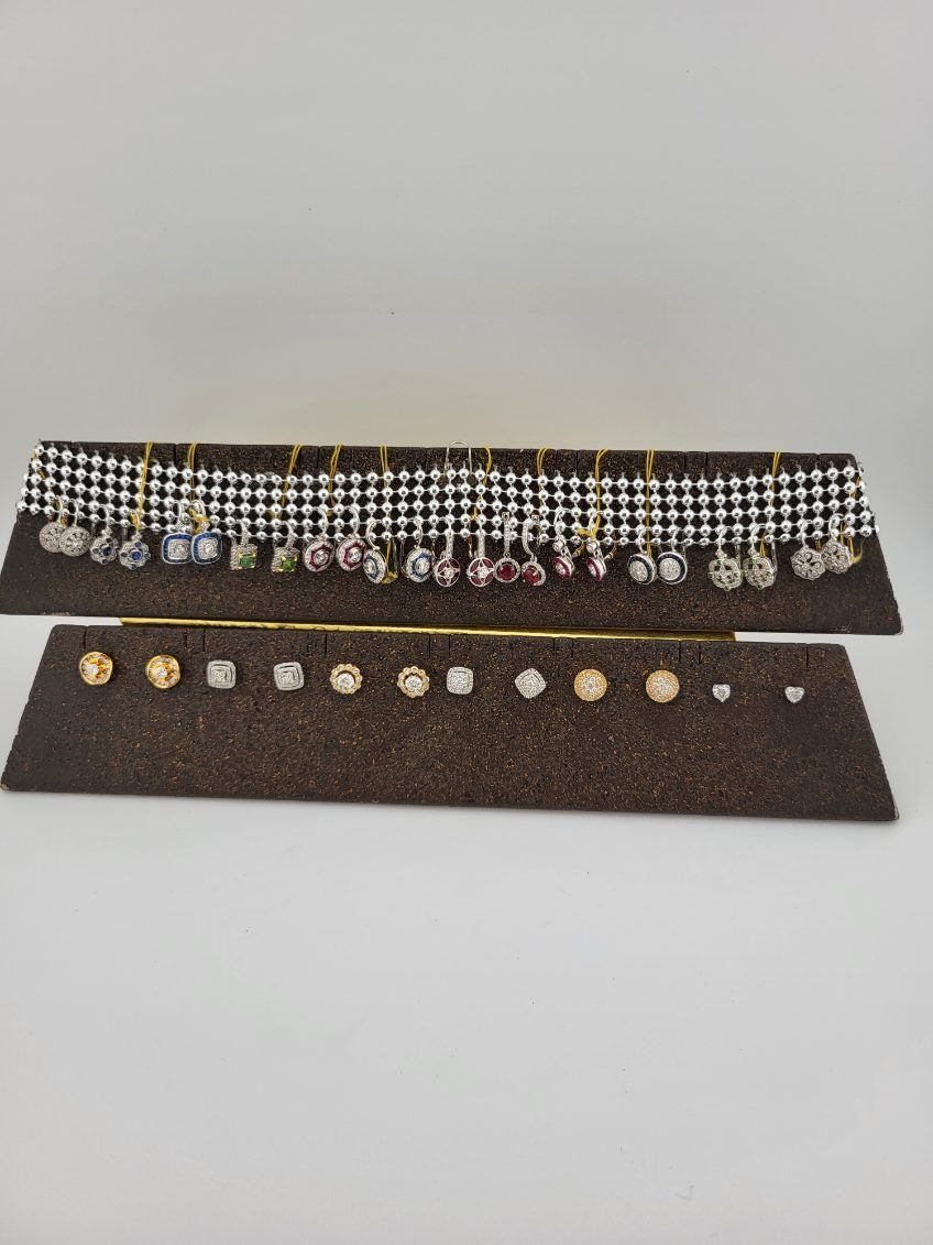 Earrings displayed on two cork boards against a white background.