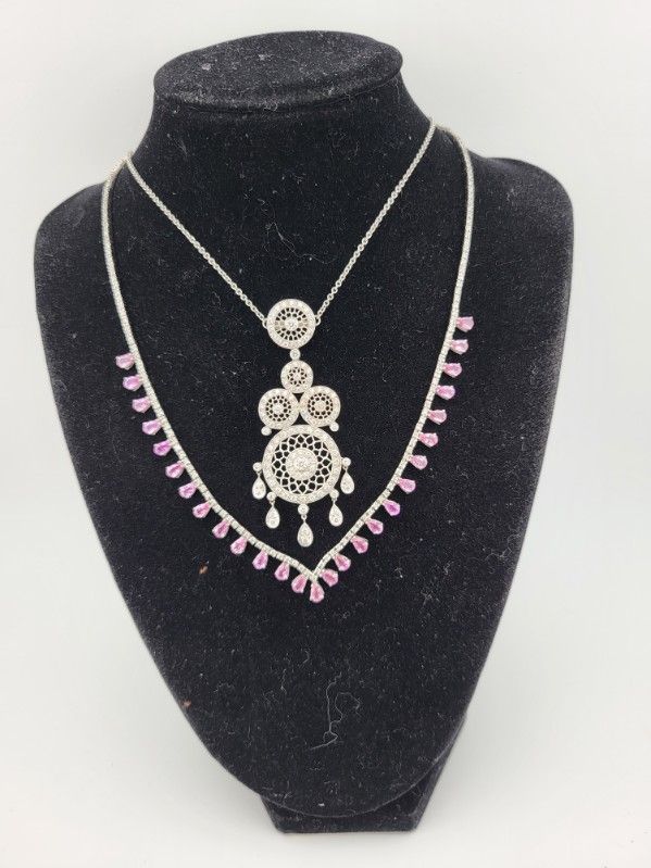 Silver and pink necklace displayed on a black velvet bust