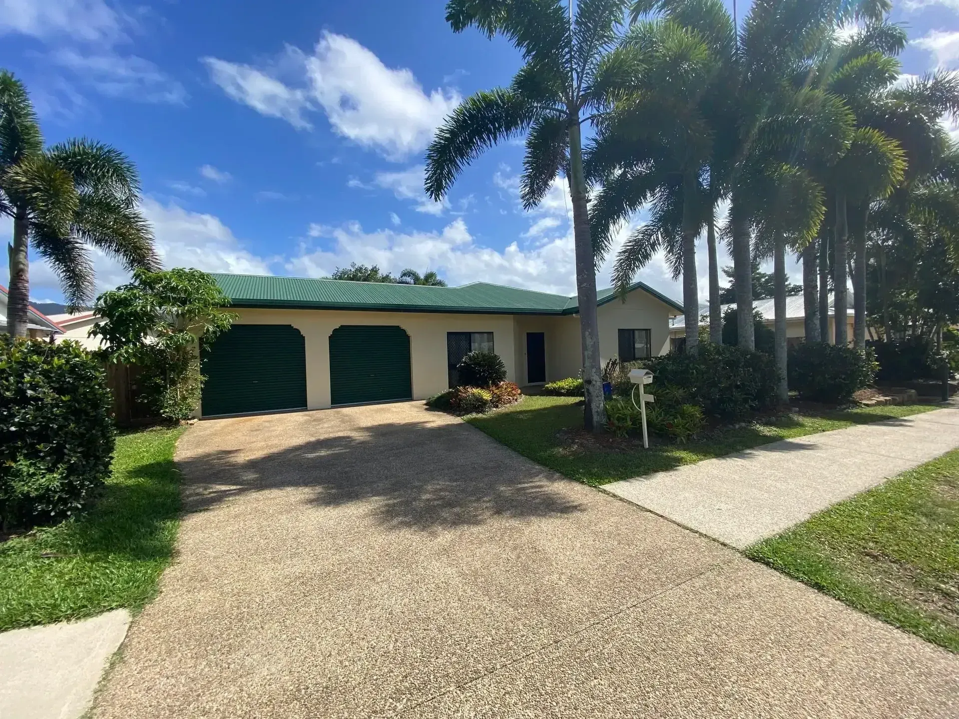 A House With A Lot Of Windows And A Lush Green Lawn In Front Of It — Rental Revolution In Manoora, QLD