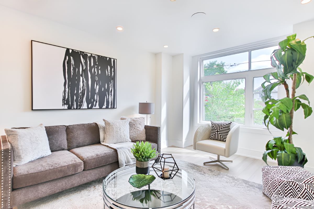 A Living Room With A Couch, Chair, And Coffee Table — Rental Revolution In Manoora, QLD