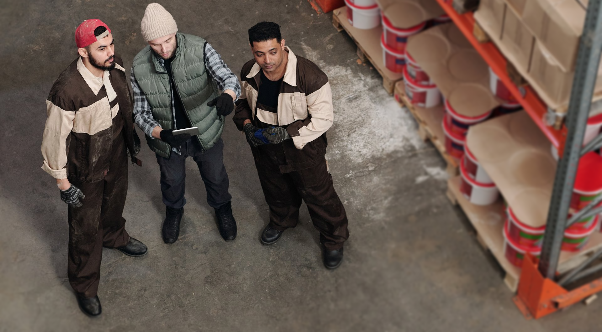 Men in a warehouse looking at home security inventory