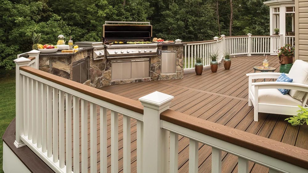 A wooden deck with a grill and chairs on it.