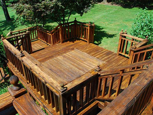 A large wooden deck with stairs leading up to it
