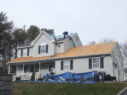 A house with a roof that is being installed