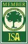 A green and white sign with a tree in the middle.