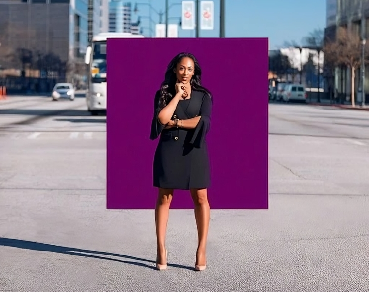A woman in a black dress is standing in front of a purple square.