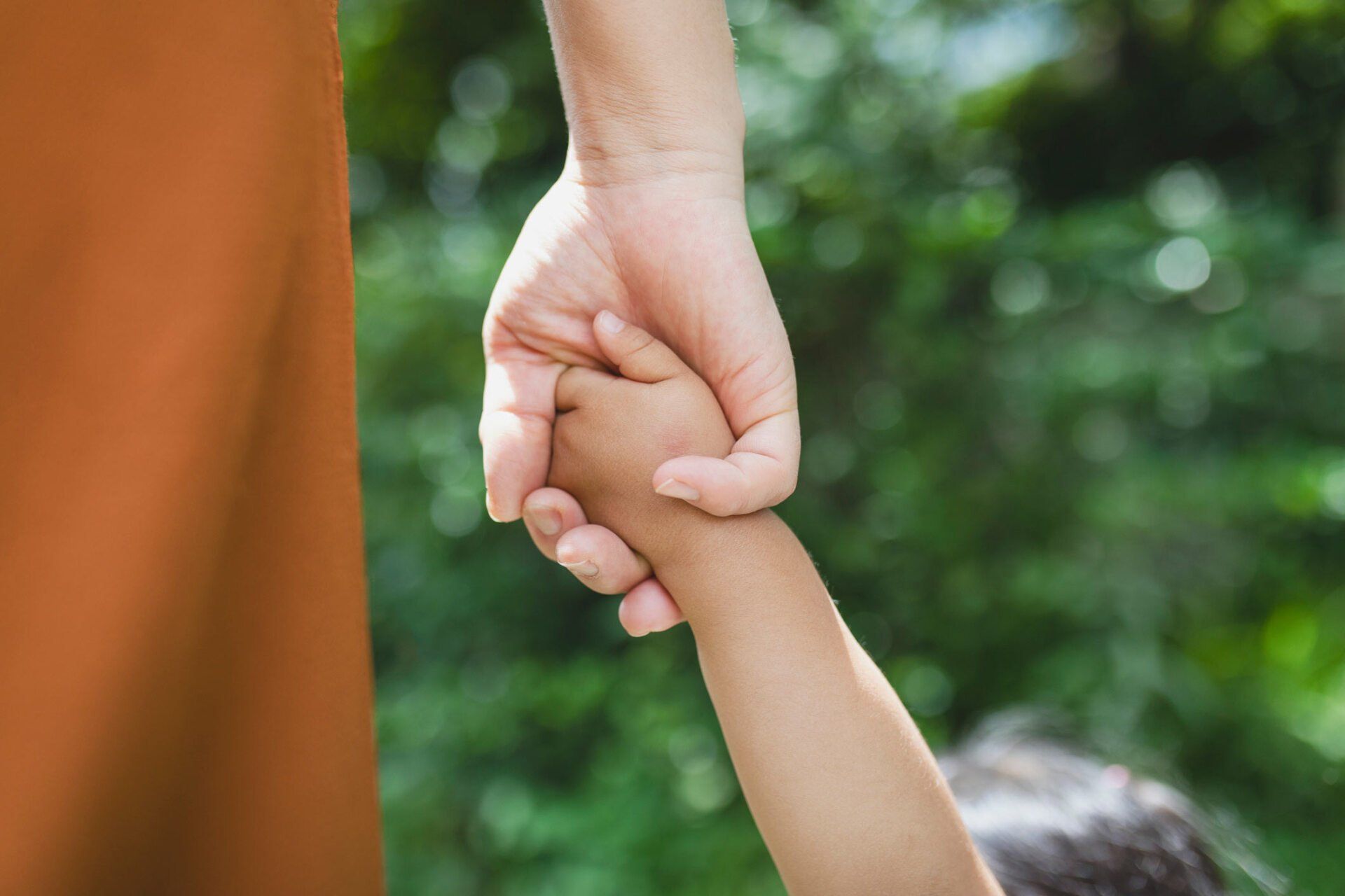 Mother holding child's hand — Jacksonville, FL — Beaches Family Law Mother holding child's hand — Jacksonville, FL — Beaches Family Law