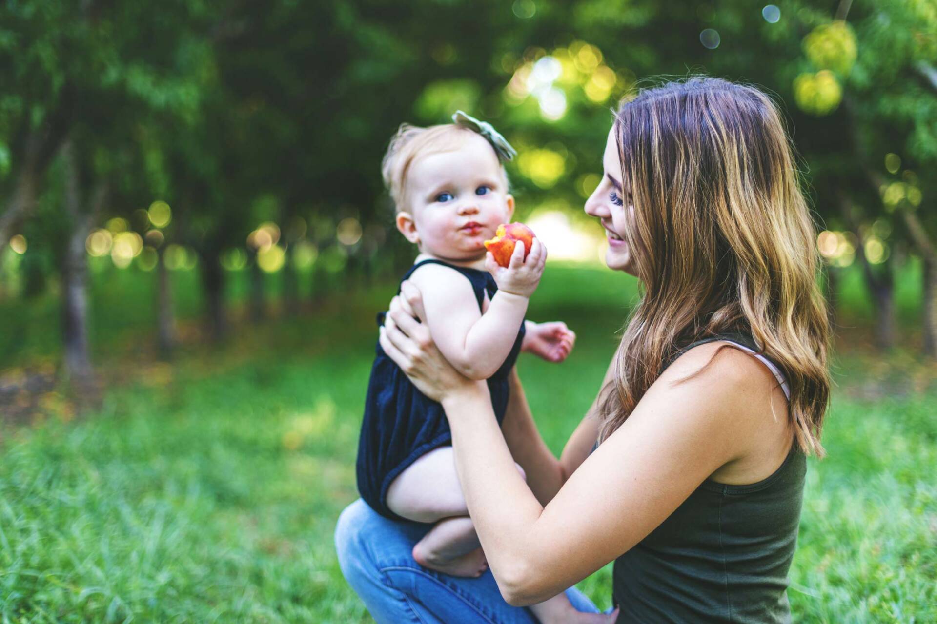 Mother holding baby that is eating — Jacksonville, FL — Beaches Family Law