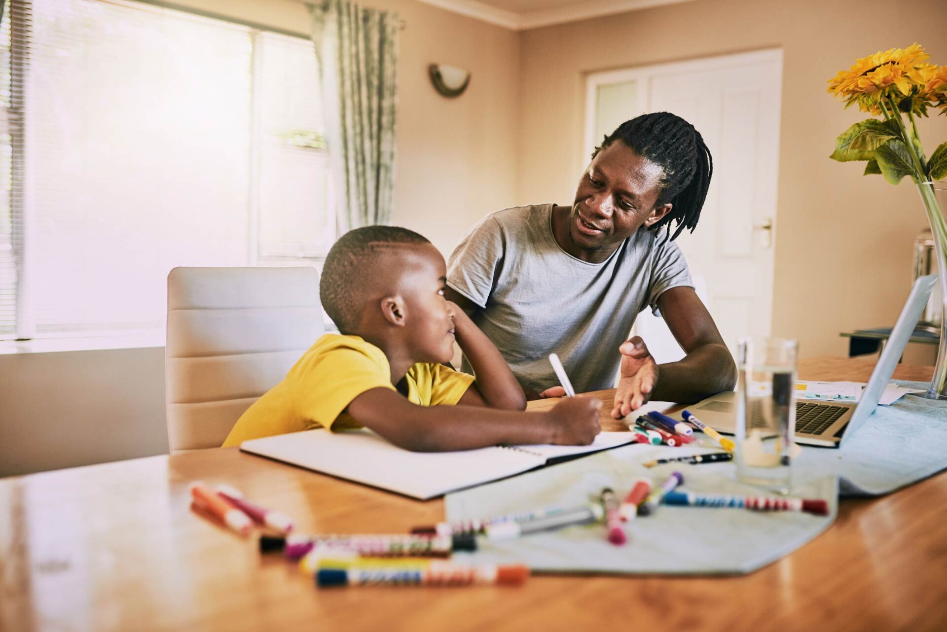 Father helping son with school works — Jacksonville, FL — Beaches Family Law Father helping son with school works — Jacksonville, FL — Beaches Family Law