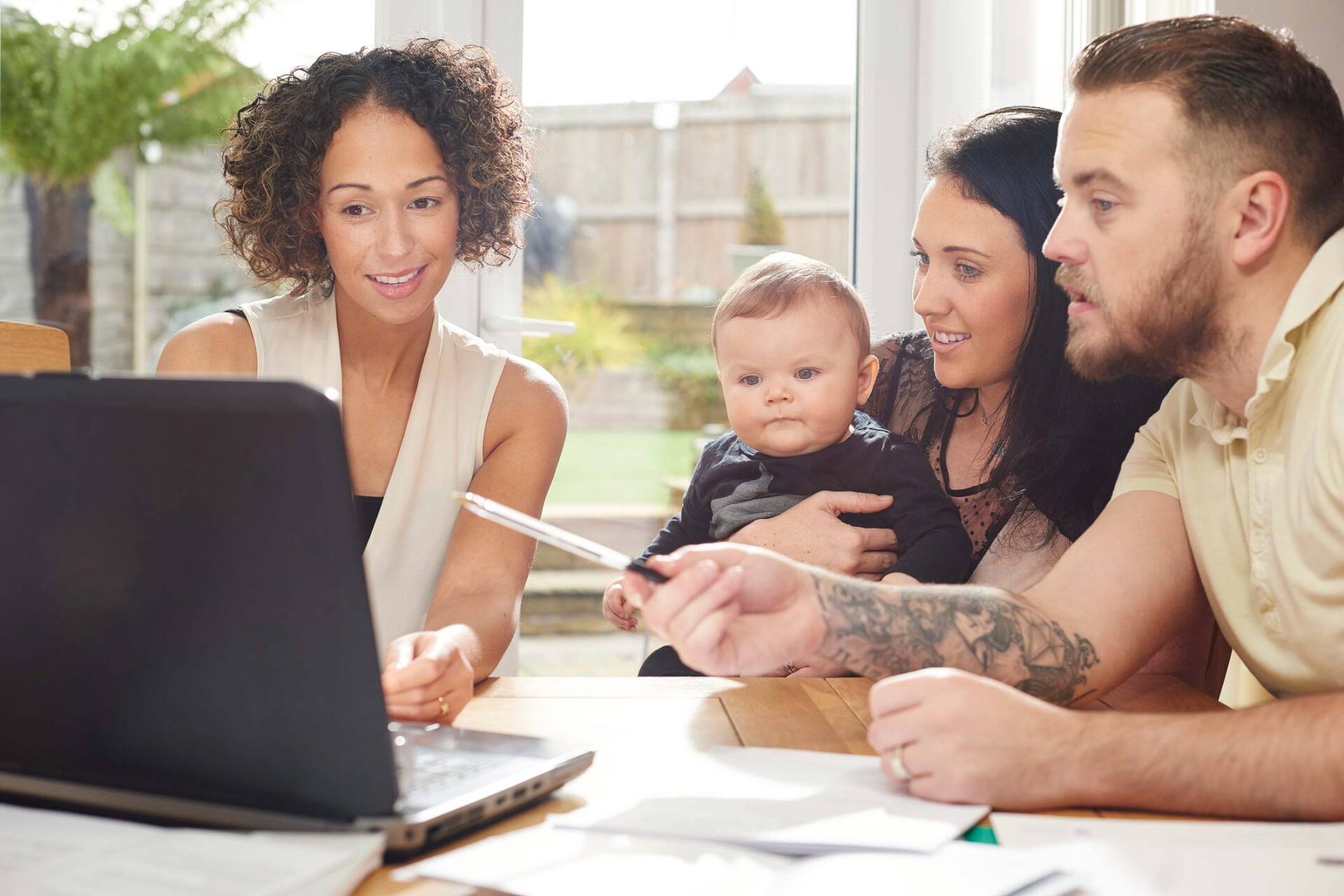 Woman talking to parents with baby — Jacksonville, FL — Beaches Family Law Woman talking to parents with baby — Jacksonville, FL — Beaches Family Law