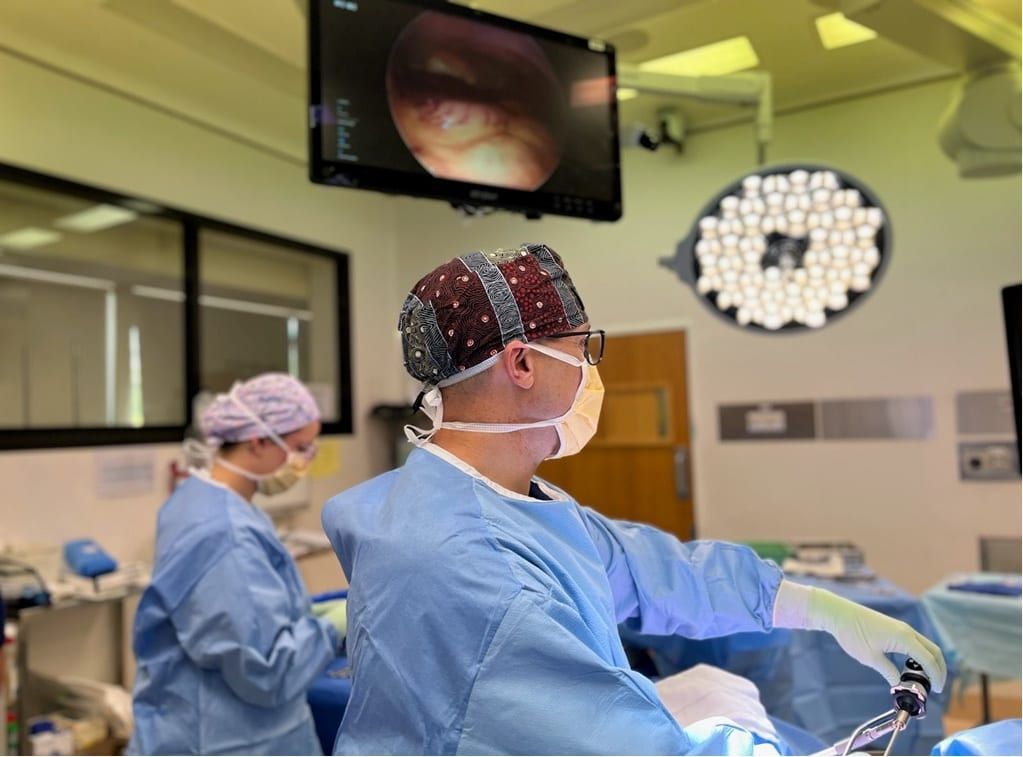 A group of surgeons are performing surgery in an operating room.