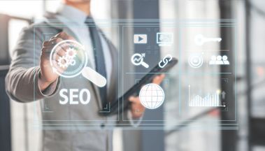 Man in suit pointing to SEO graphic with digital icons.