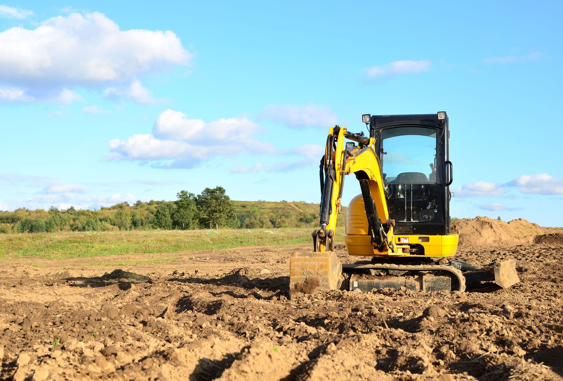 excavator tilling land
