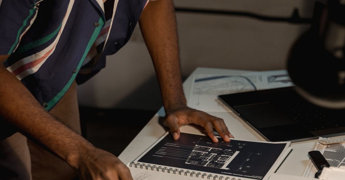 person reviewing a notebook on desk to calculate rates