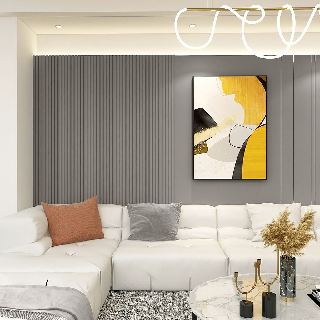 Sala de estar moderna con sofá modular blanco, pared acanalada gris, arte abstracto y mesa de centro de mármol.