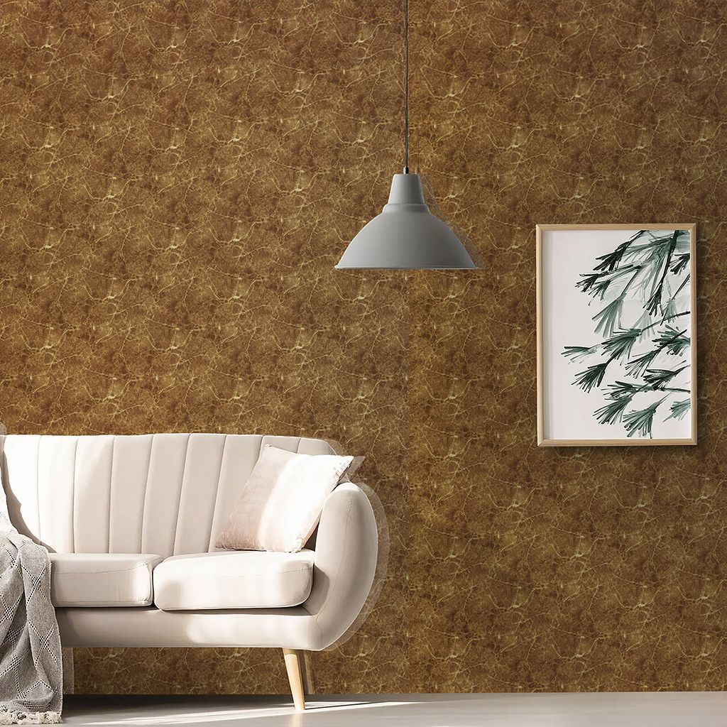 Sofá blanco bajo una lámpara colgante gris junto a un cuadro botánico enmarcado sobre una pared de textura marrón.
