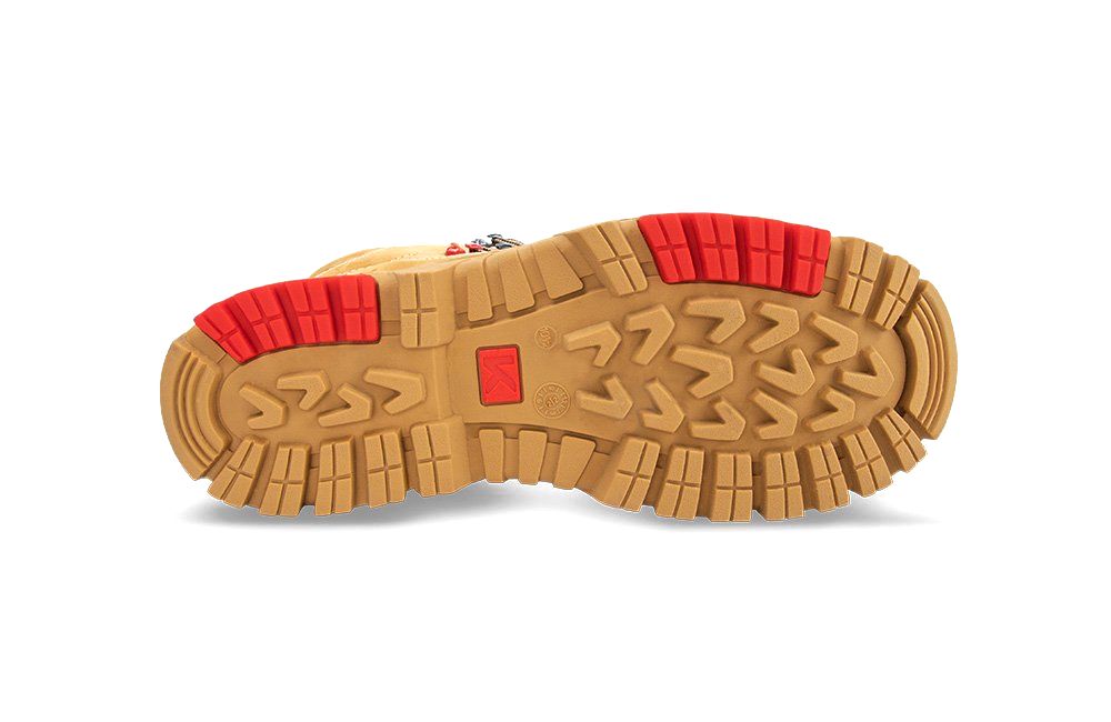 The bottom of a pair of boots with red rubber soles on a white background.