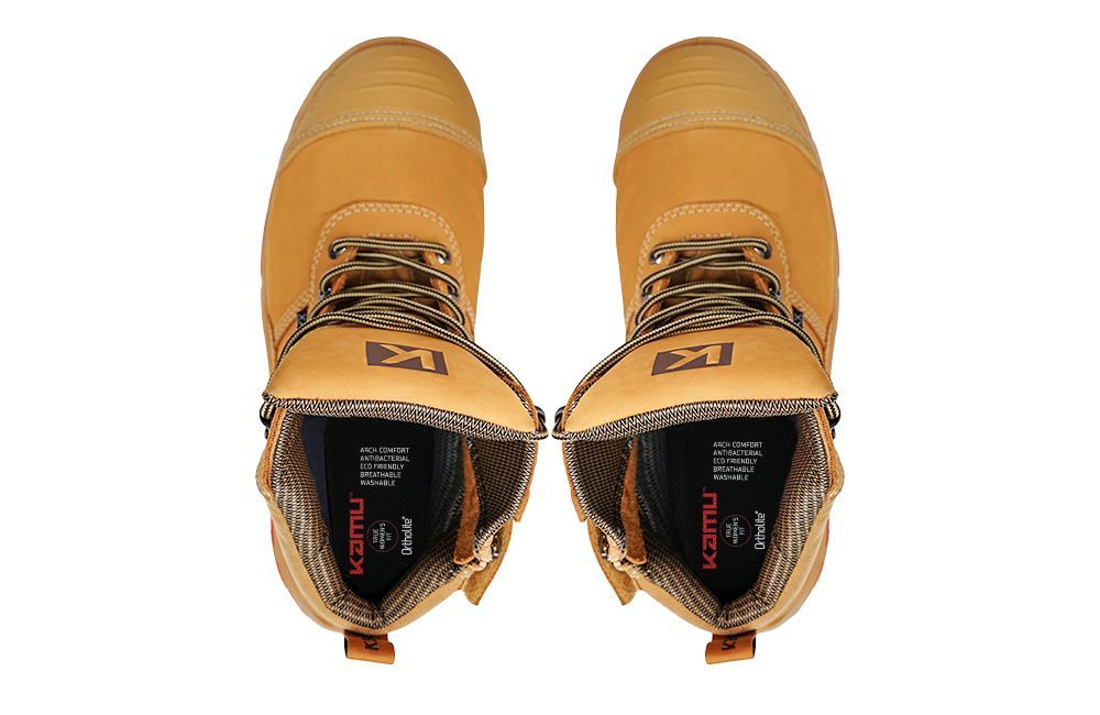 A pair of brown boots with the word kamui on the inside