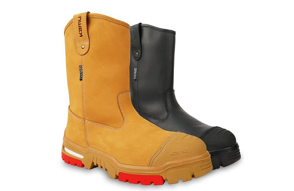 A pair of black and tan safety boots on a white background.