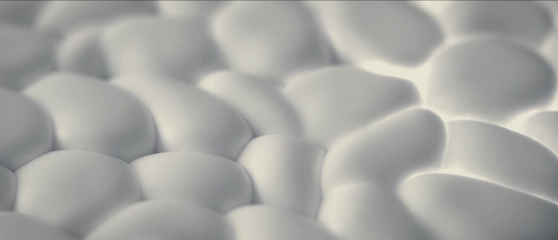 A close up of a pile of white eggs on a table.