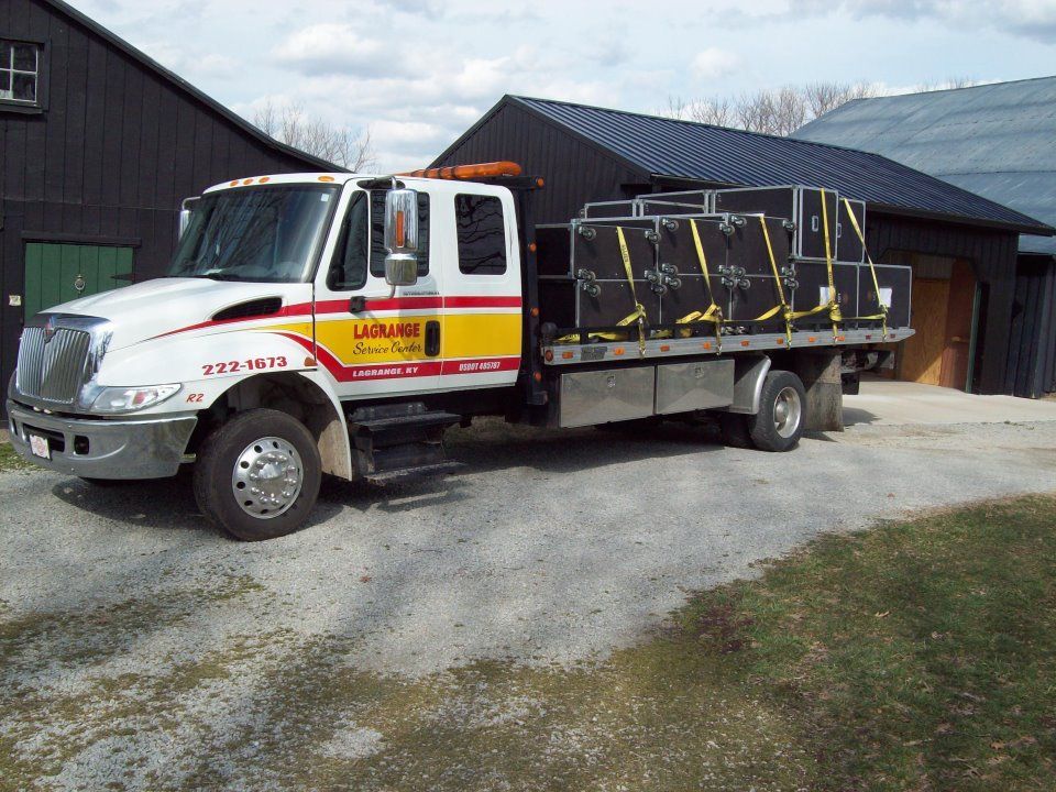 A tow truck is parked in front of a building