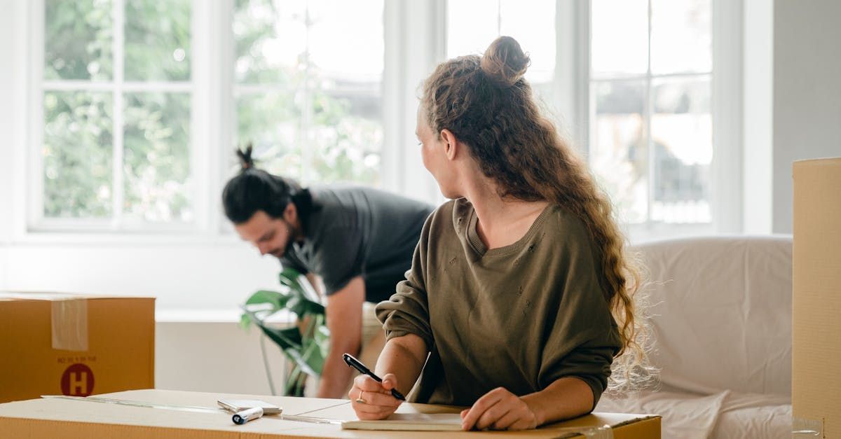 A man and a woman are moving into a new home.