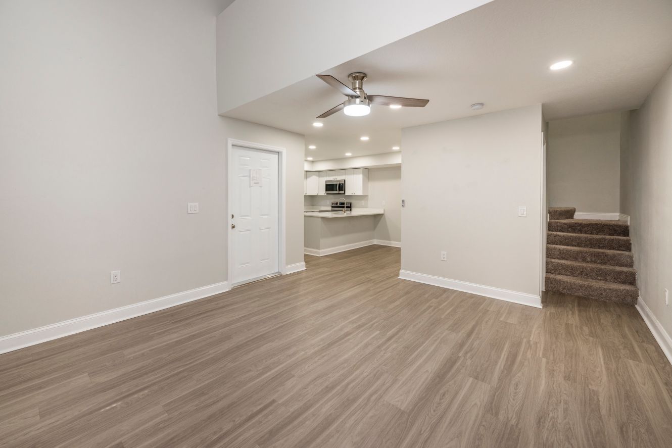 Open plan living room with light colored wood floors