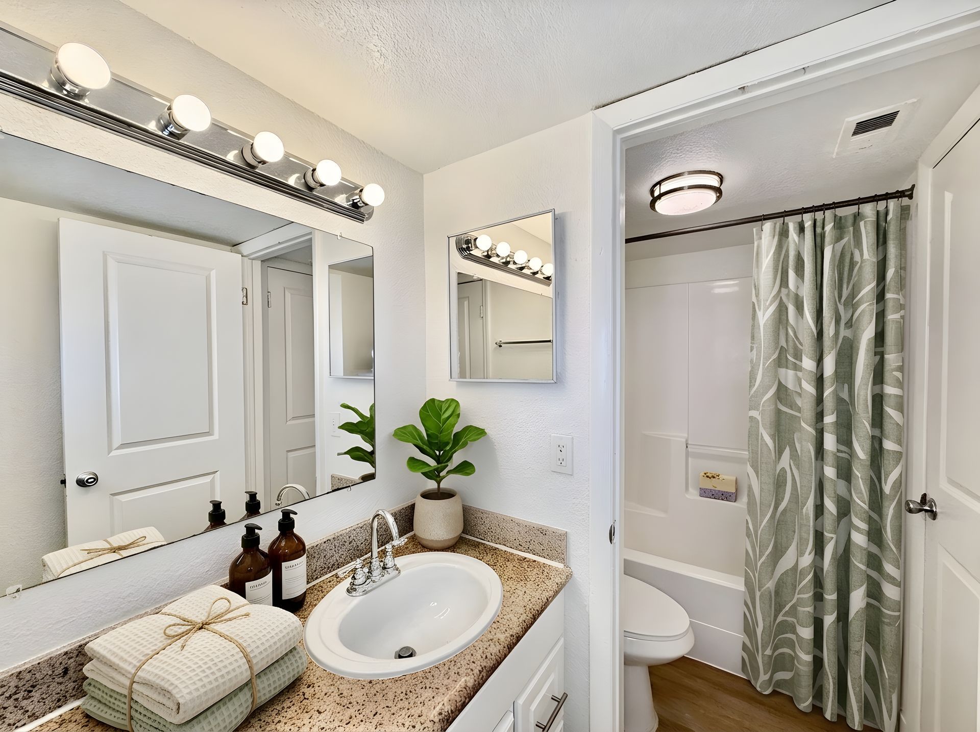 bathroom with green shower curtain and large mirror