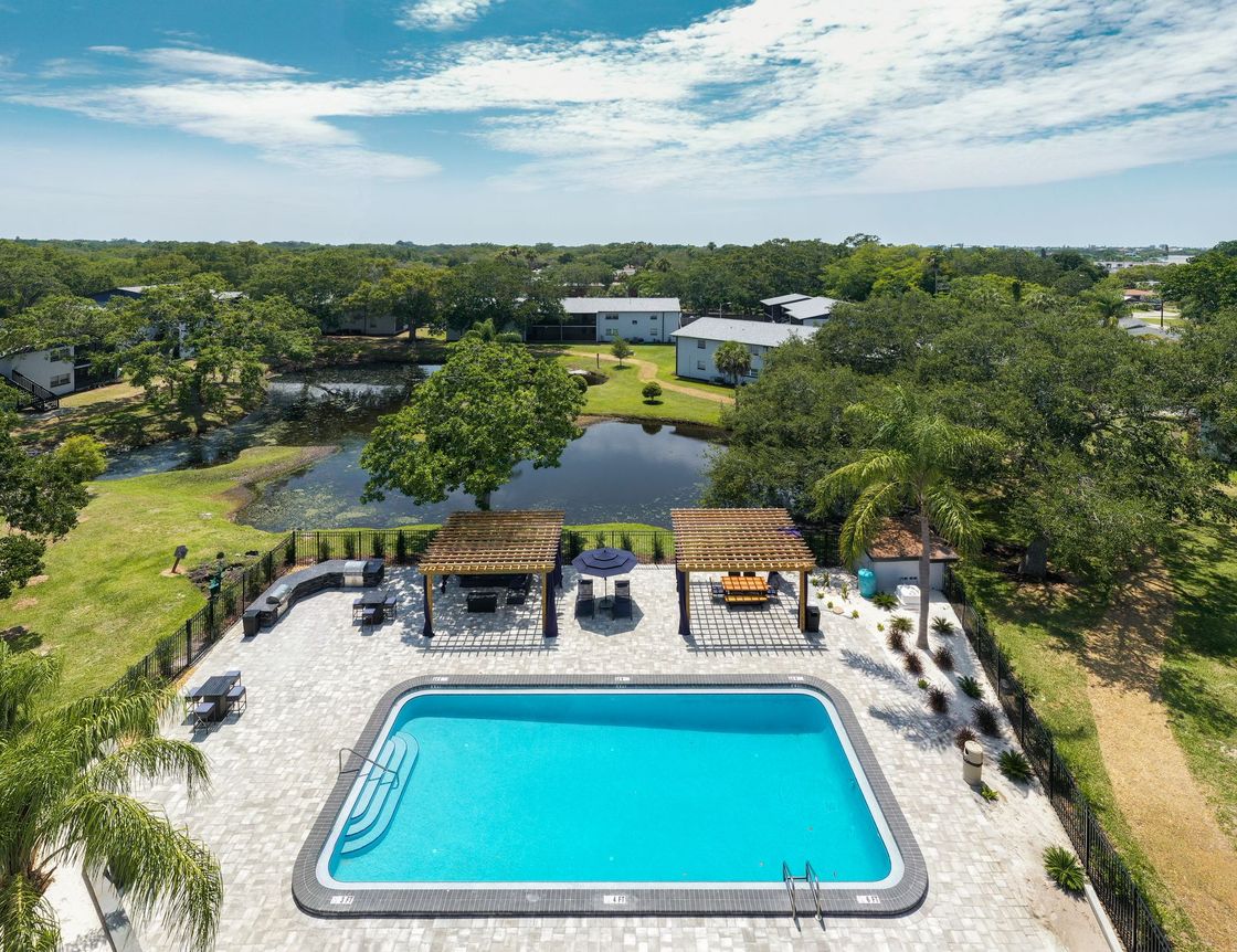 Aerial view of pool area and the lake behind it