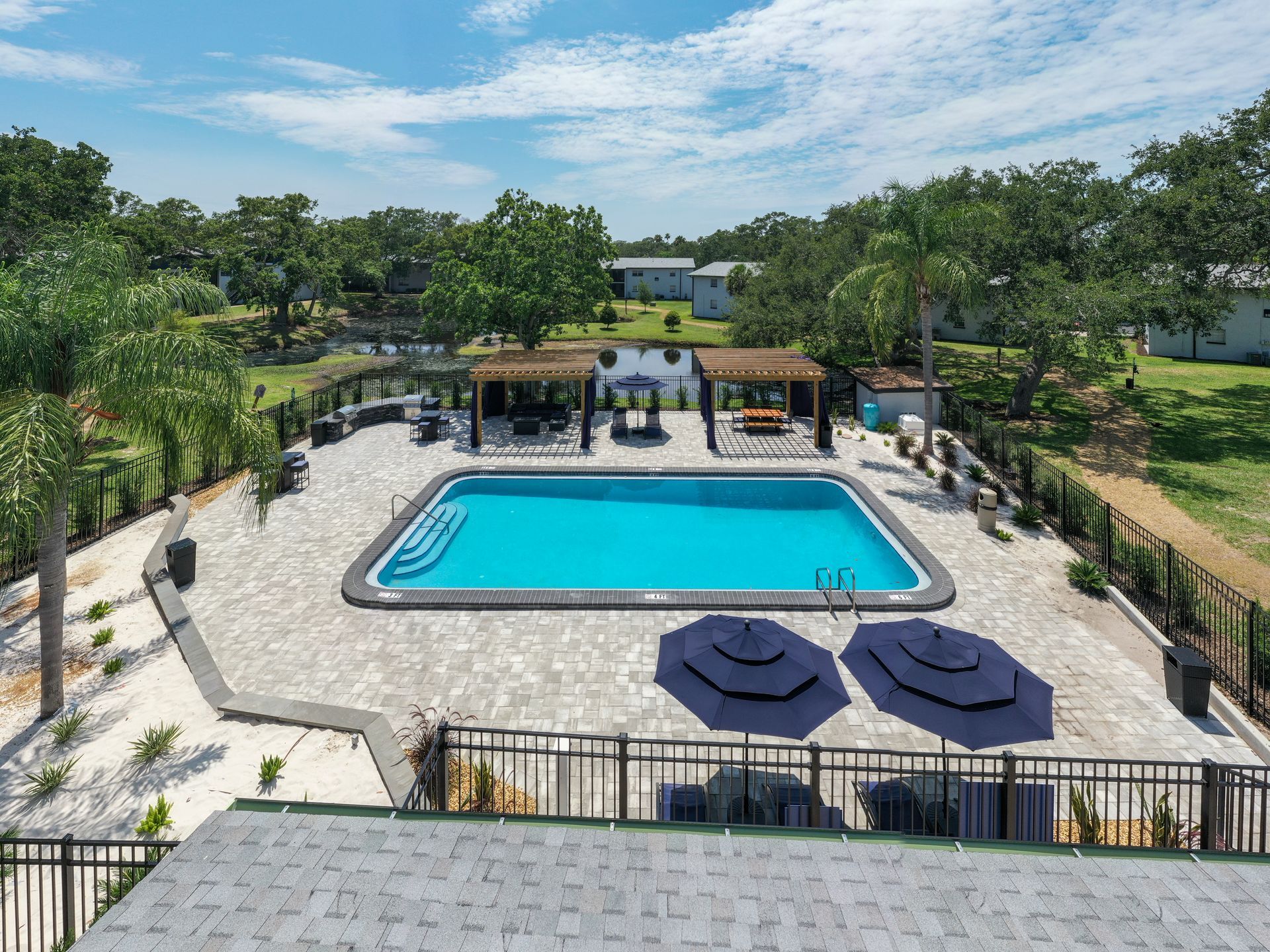 Aerial view of pool area and surrounding green space