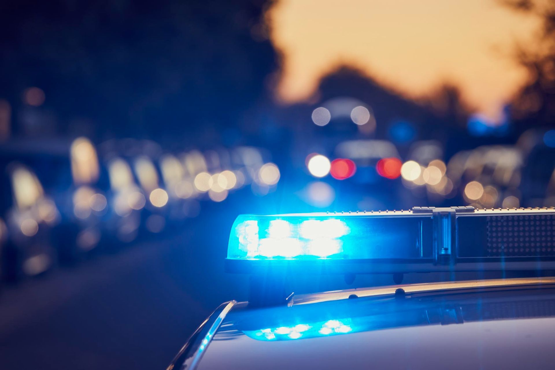 A police car with a blue light on top of it.