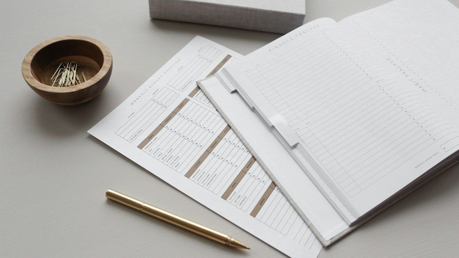 A pencil is sitting on top of a piece of paper on a table.