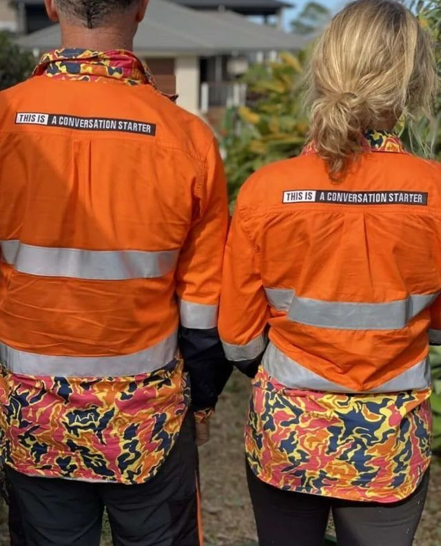a Man and a Woman Are Standing Next to Each Other Wearing Orange Safety Shirts — Chris Hackett Tree Services In Ballina, NSW