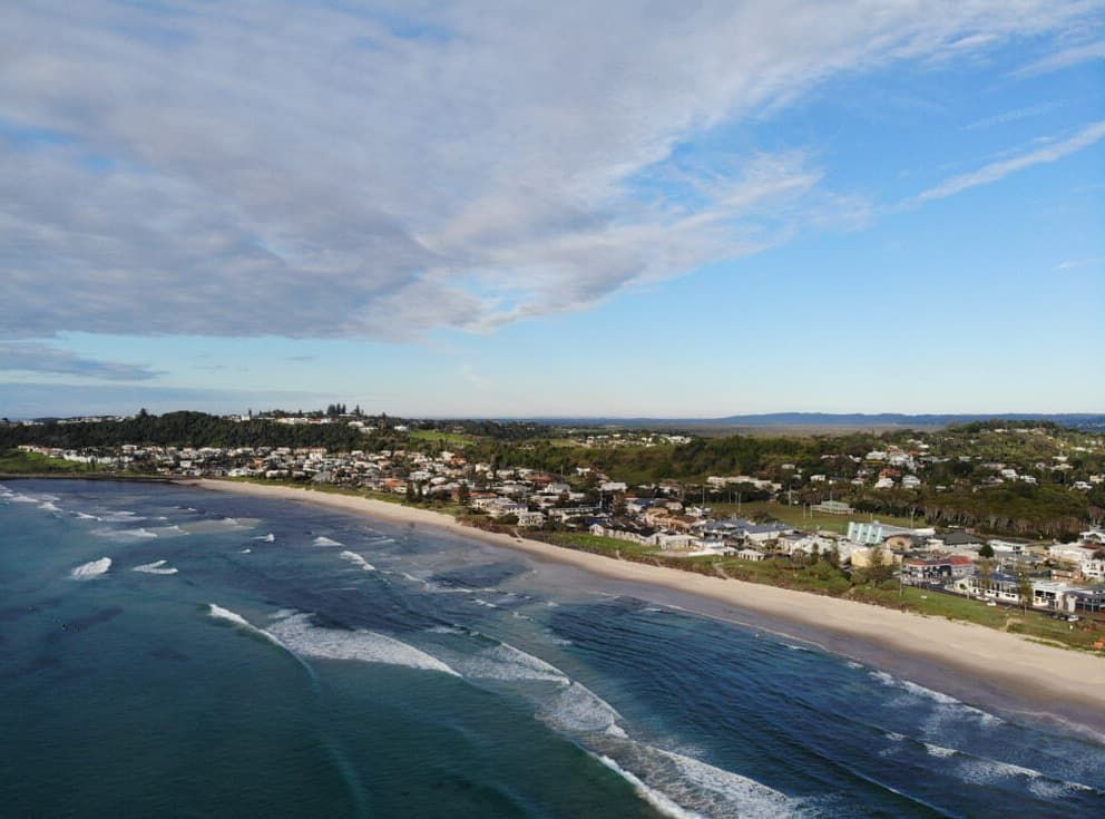 An Aerial View Of A Beach With Waves Crashing On The Shore — Chris Hackett Tree Services In Lennox Head, NSW