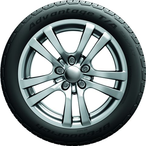Silver alloy car wheel with black tire on a white background