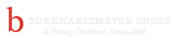 White logo with a red lowercase “b” and faint gray text reading “Woolly Institute” with a small tagline below.