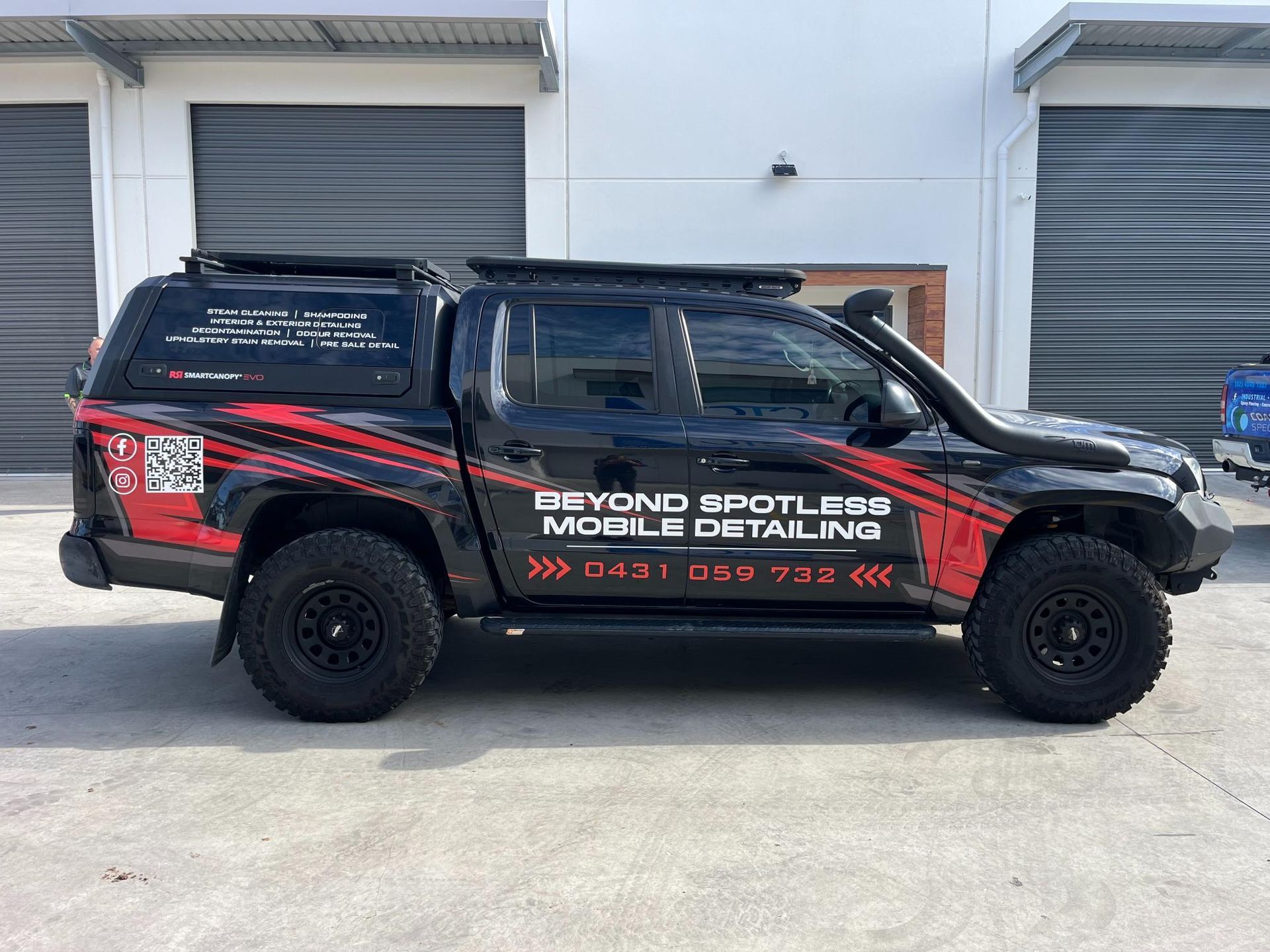 Black truck with Beyond Spotless Mobile Detailing branding.