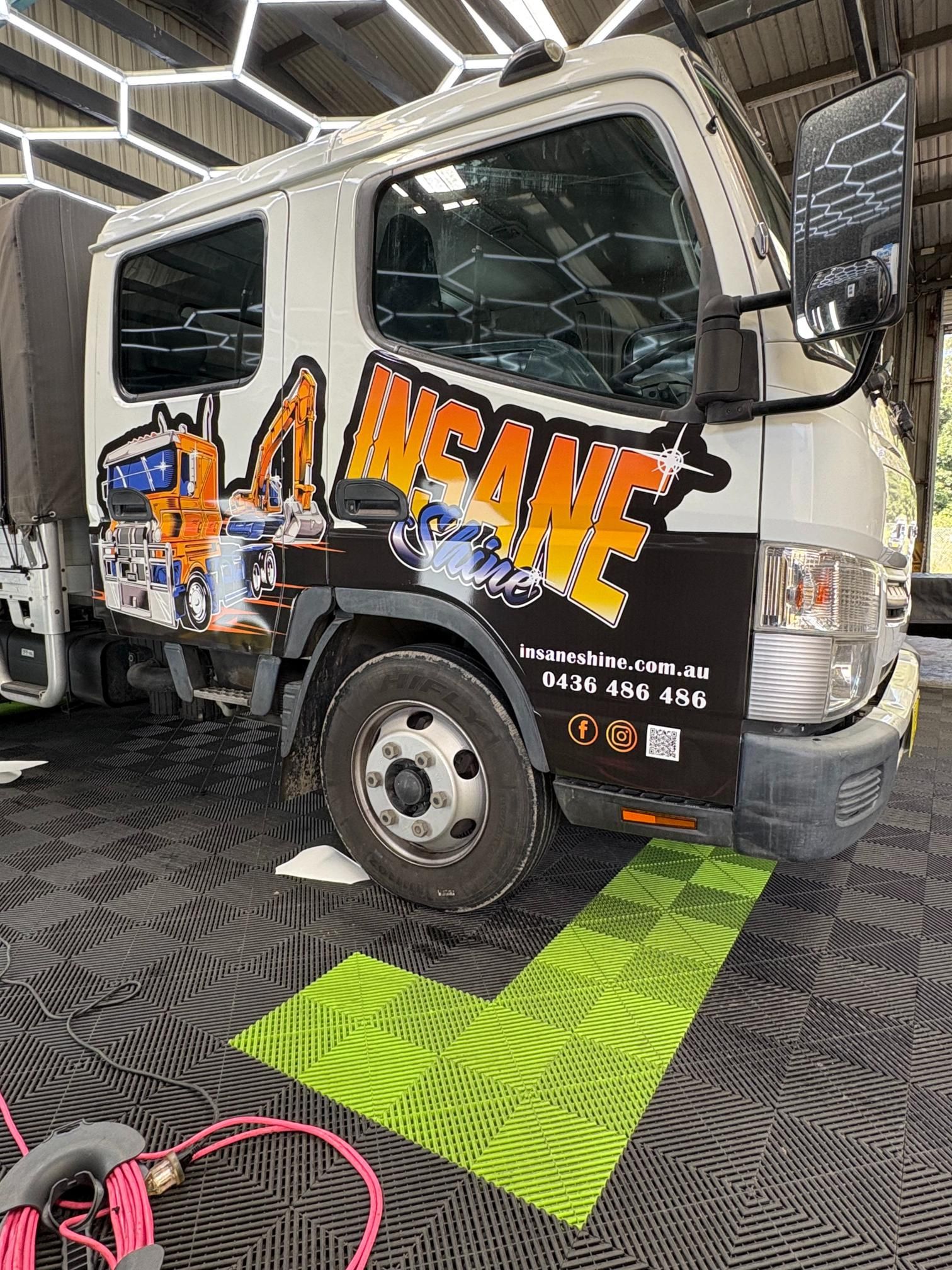 White Truck with Insane Logo, Parked on Green Checkered Mats — Stuckup Industries in Morisset, NSW