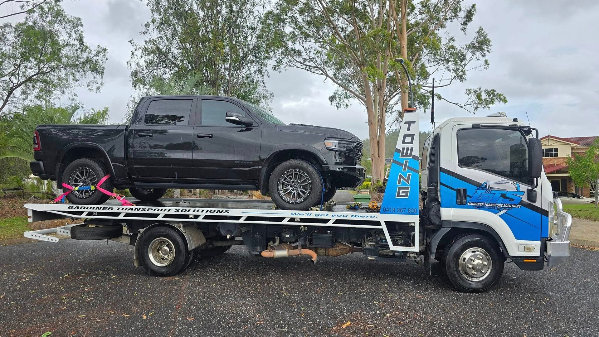 Black Pickup Truck Loaded on a White Tow Truck on a Road — GTS - Gardiner Transport Solutions in Berserker, QLD
