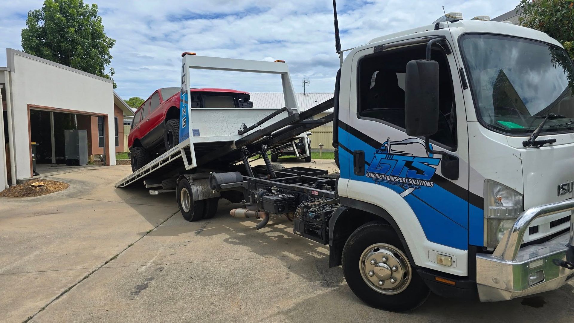 Tow Truck With a Red Suv on Its Flatbed — GTS - Gardiner Transport Solutions in Berserker, QLD
