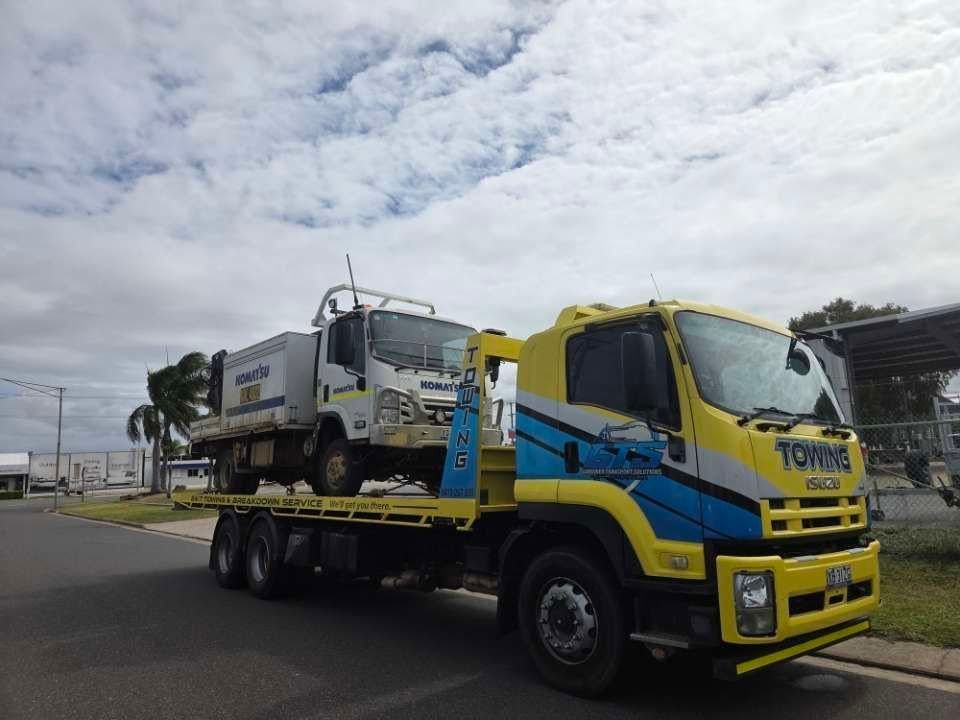Yellow Tow Truck Carrying a White Truck on a Sunny Day — GTS - Gardiner Transport Solutions in Berserker, QLD