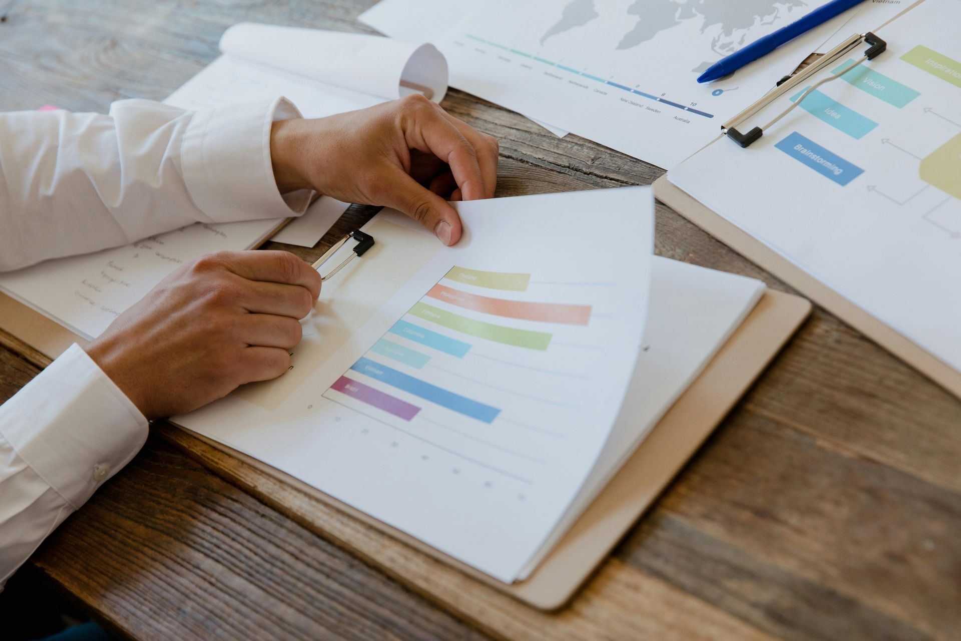 A person is looking at a graph on a clipboard.