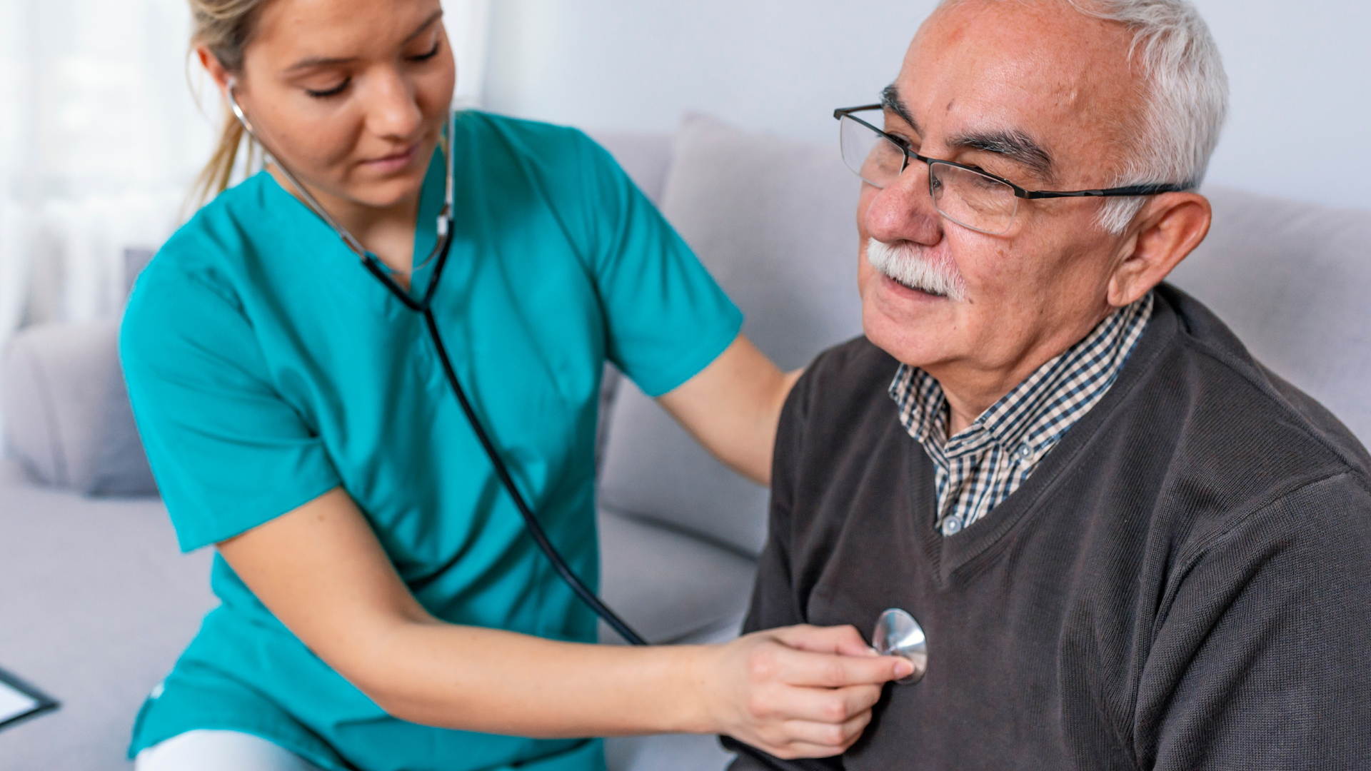 Nurse using a stethoscope to check an older man’s chest in a clinic setting