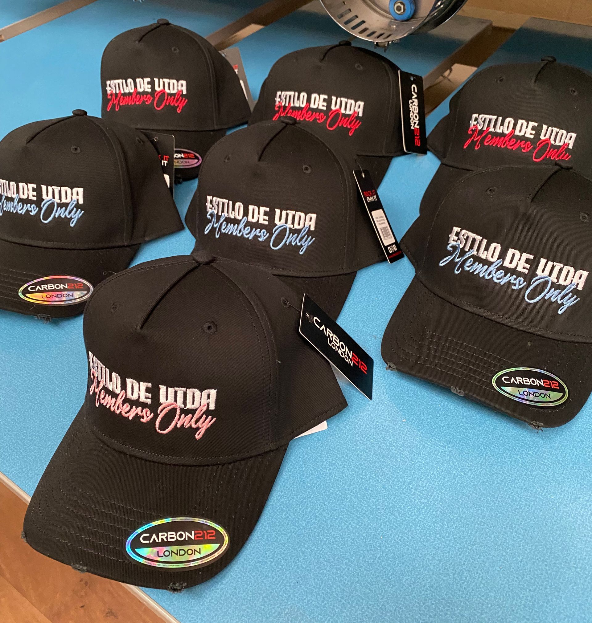 Black baseball caps with the phrase 
