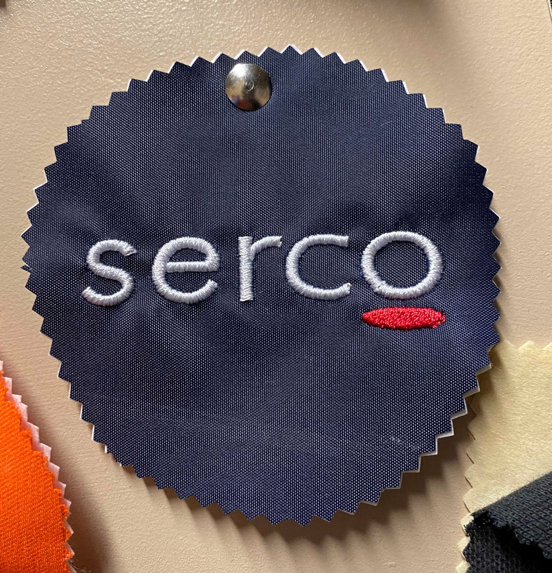Dark blue fabric swatch with embroidered white 
