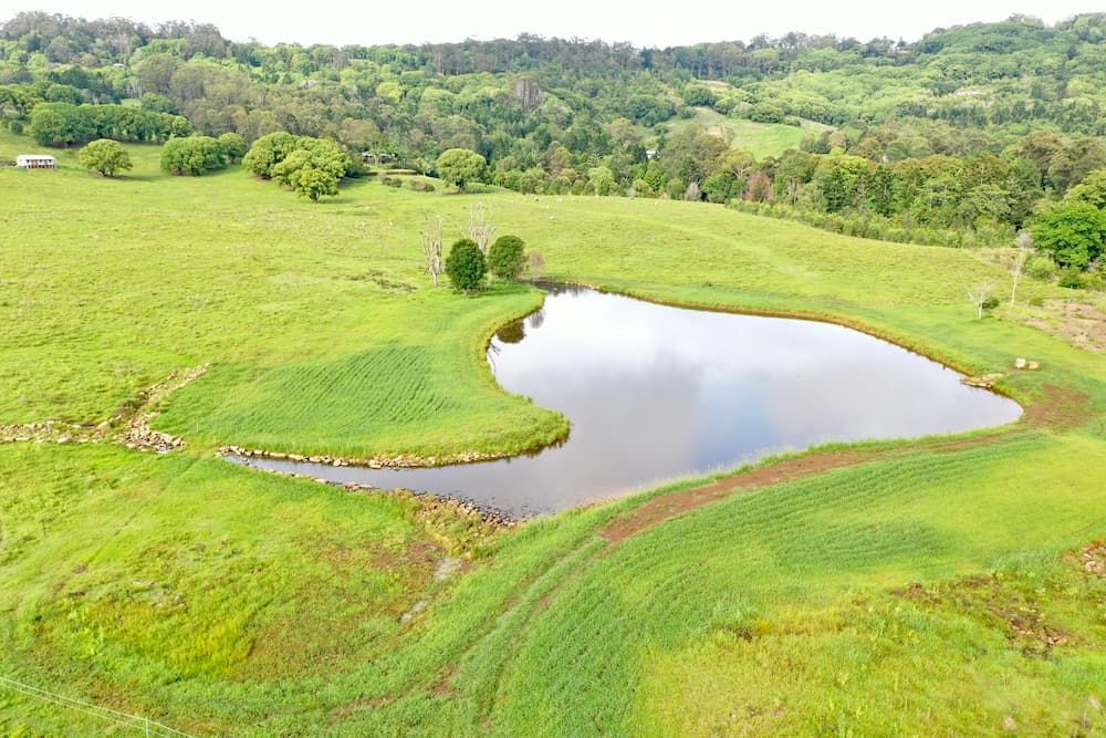An Aerial View Of A Small Pond In The Middle Of A Grassy Field — J & M Bashforth & Sons In Brunswick Heads, NSW